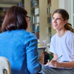Christian college librarian interviews college student.